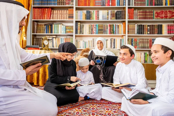 Happy arabic family reading and learning quraan during ramadan