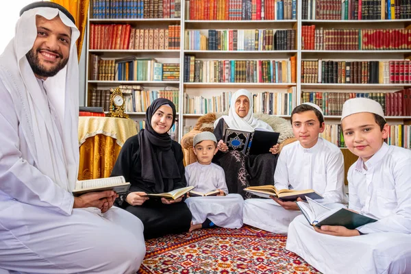 Happy arabic family reading and learning quraan during ramadan