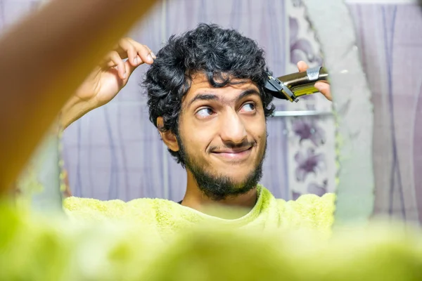 一个阿拉伯穆斯林男人自己剪头发 — 图库照片
