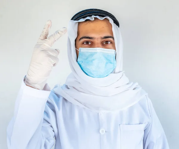 Arabic muslim doctor wearing mask with hygiene products