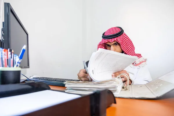 Arabic muslim employee completing the task in his hand