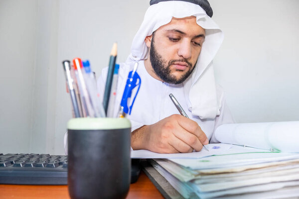 Arabic muslim man working on some paper