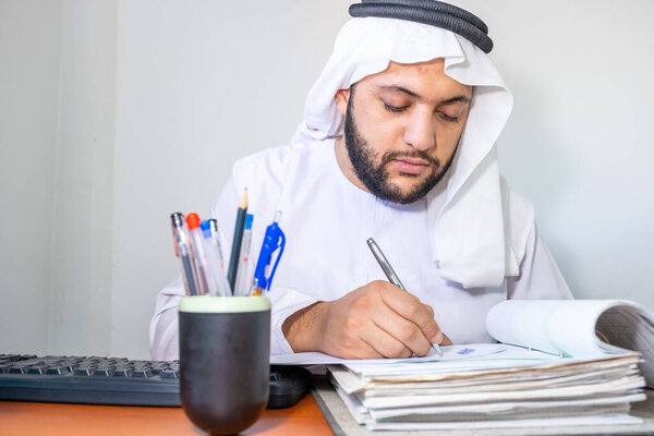 Arabic muslim man working on some paper