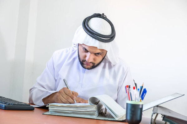 Arabic muslim man working on some paper