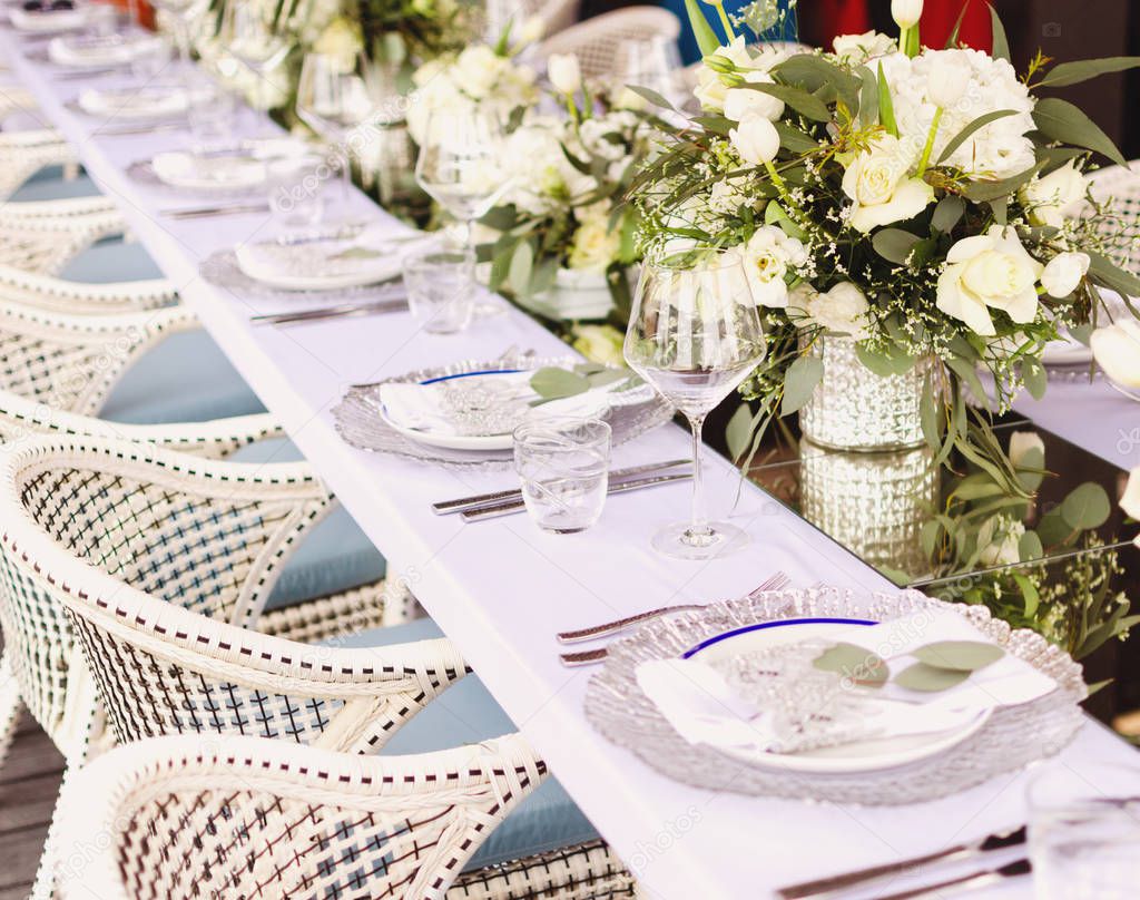 Set table for a white and aqua blue beach wedding dinner decorated selective fokus