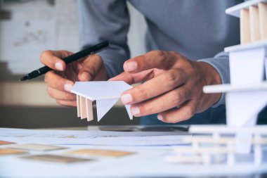 Mimari tasarım tasarımı çizim planları çiziyor ve mimar stüdyosunda mimari yapı modelleri yapıyor.