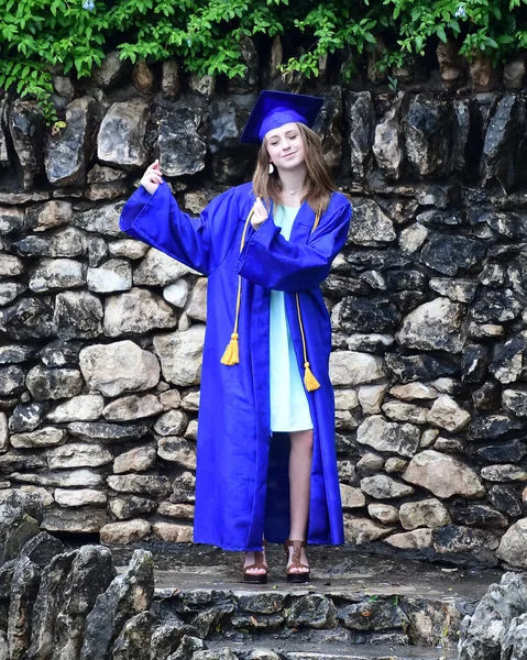 Young Female High School Senior posing for Senior photos in a beautiful park setting