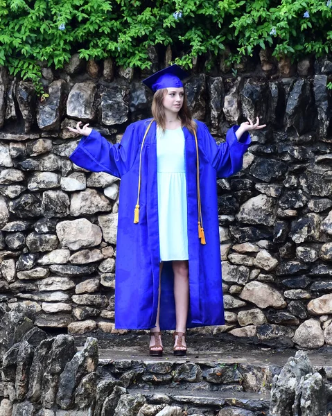 Young Female High School Senior posing for Senior photos in a beautiful park setting