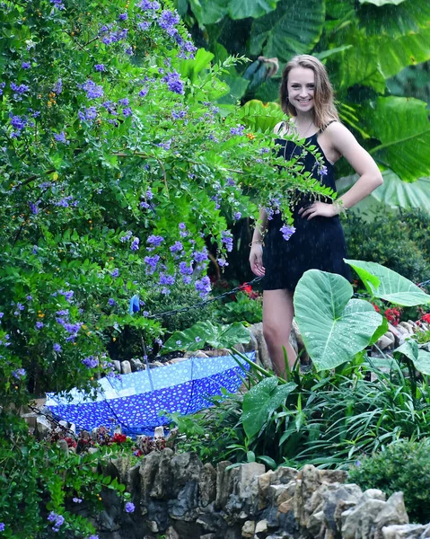 Young Female High School Senior posing for Senior photos in a beautiful park setting