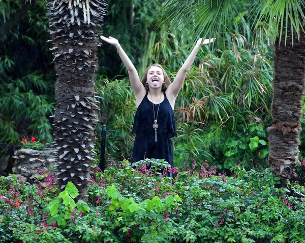 Young Female High School Senior posing for Senior photos in a beautiful park setting