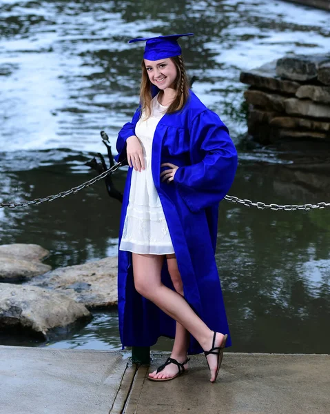 Young Female High School Senior posing for Senior photos in a beautiful park setting