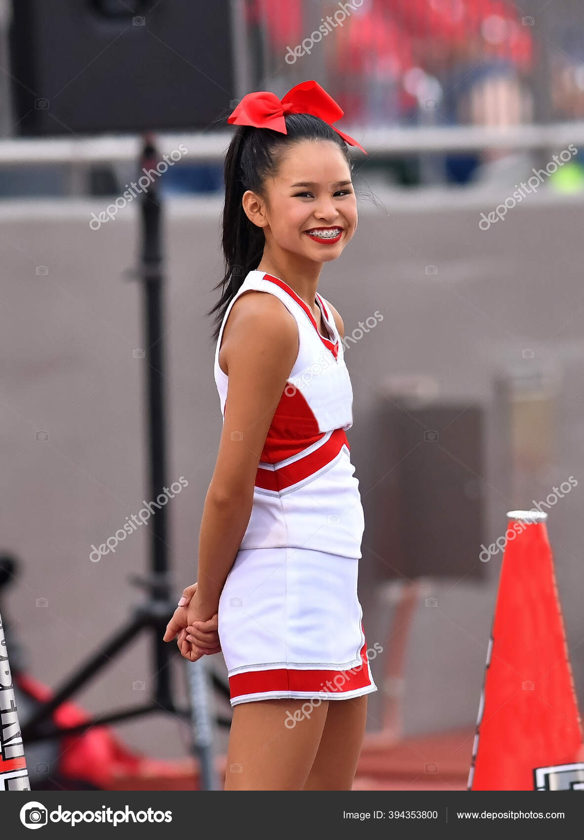 Cute Asian American Cheerleader Performing High School Football Game