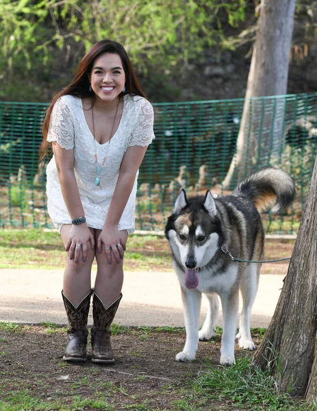 Young Female High School Senior posing for Senior photos in a beautiful park setting