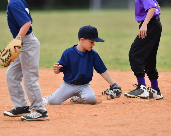 Action photo of handsome young baseball player making amazing plays during a baseball game