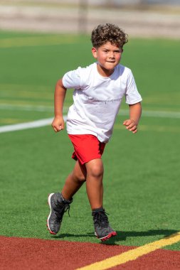 Bayrak futbolunda oynayan tatlı bir çocuk.