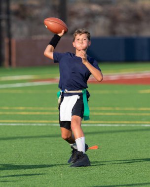 Genç atletik çocuk bayrak futbolunda oynuyor.