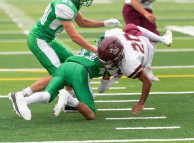 İnanılmaz sporcular, rekabetçi bir futbol maçında harika yakalayıp koşuyor.