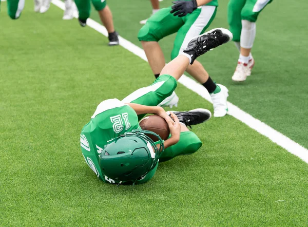 Amazing athletes making great catches and runs during a competitive football game