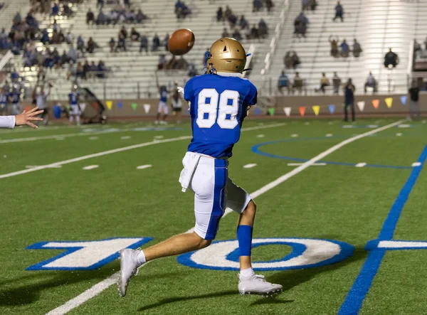 Amazing athletes making great catches and runs during a competitive football game