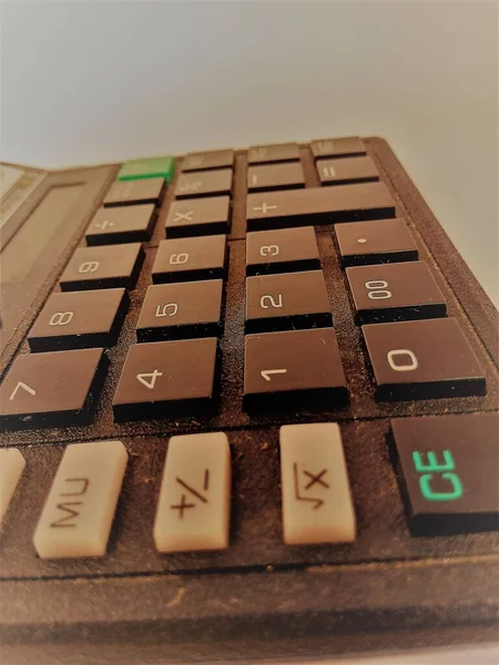A Closeup shot of a calculator keys from different angles.Can see the colored keys used in it for quick notice.The calculator body is black in color and keys are black and white colored.