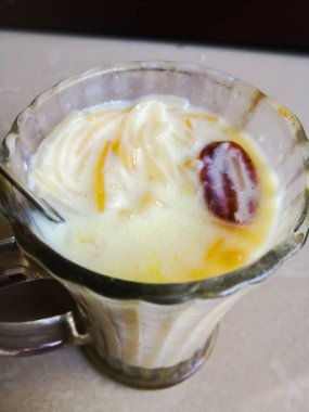 Onam special Vermicelli payasam made in a glass with a spoon with a spoon. Special desert or sweet made of vermicelli and milk of a glass. The glass is a spoon in the top..