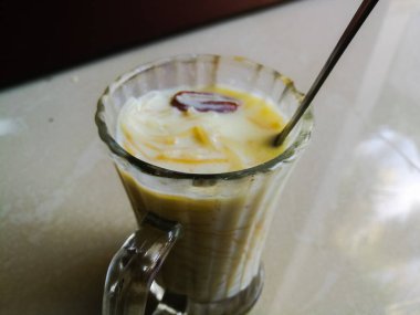 Onam special Vermicelli payasam made in a glass with a spoon with a spoon. Special desert or sweet made of vermicelli and milk of a glass. The glass is a spoon in the top..