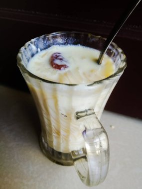 Onam special Vermicelli payasam made in a glass with a spoon with a spoon. Special desert or sweet made of vermicelli and milk of a glass. The glass is a spoon in the top..