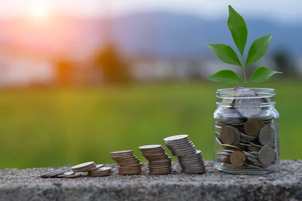 Saving Money Hand Puting Coins Jug Glass Pile Coins Resting — Stock Photo, Image