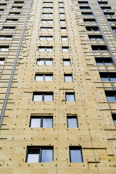 cladding of a multi-storey building with insulation, construction of a house, exterior decoration of a building, multi-storey building, glass wool