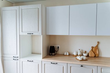 Mutfakta beyaz çay seti, mutfak gereçleri, dört bardak.