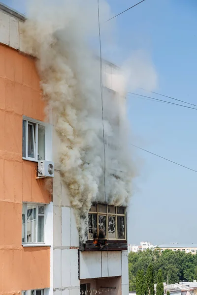 fire on the balcony of a multi-storey building, black clouds of smoke, apartment smoke, extinguishing fire in a residential building, fire escape, emergency, fire, open fire, house fire