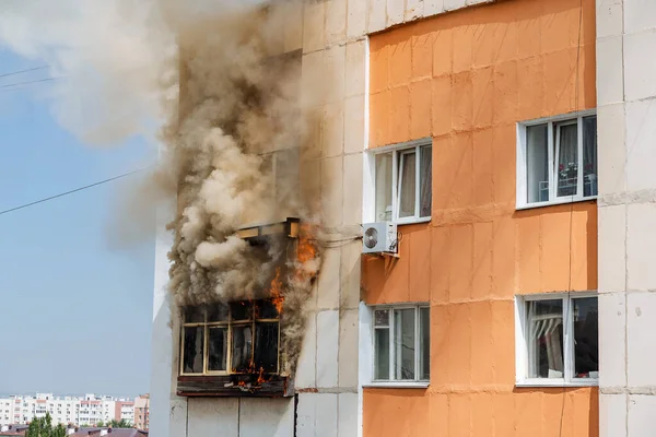 fire on the balcony of a multi-storey building, black clouds of smoke, apartment smoke, extinguishing fire in a residential building, fire escape, emergency, fire, open fire, house fire