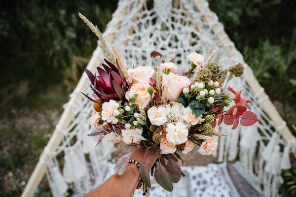 花嫁の花束 あなたの手で結婚式の花束を保持し サテンリボンは花嫁のドレス 花屋によって作られた新鮮な花の背景に バラの結婚式の花束を飾る — ストック写真