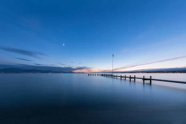 BRIDGE TO THE LAKE IN BLUE HOUR, PHOTO OF A BLUE LAKE WITH BRIDGE AT SUNSET WITH COPY SPACE