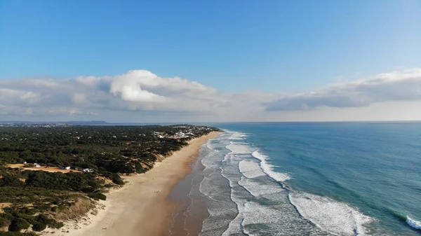 Beyaz kumsalda hava manzaralı dalgalar kopuyor. Deniz dalgaları güzel sahil manzaralı insansız hava aracı görüntülerinde 4k