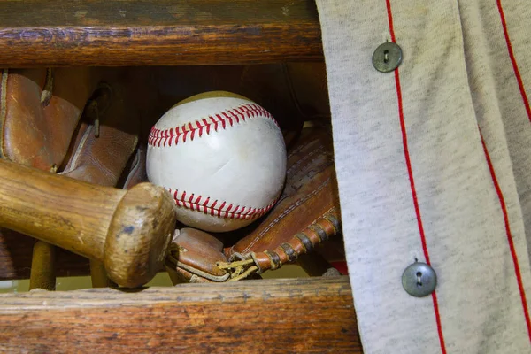 Vintage baseball with bat, glove and jersey.