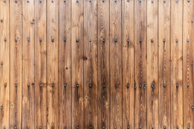 Brown rustic wood wall covering made of vertical boards with big decorative nails clipart