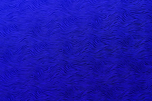 Texture with abstract wavy filigree royal blue pattern in closeup