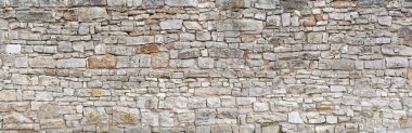 Panorama - Old gray wall of rough, many small, rectangular hewn natural stones clipart