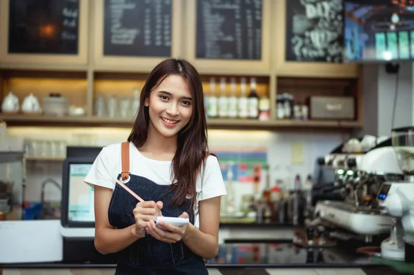 Yeni nesil kadınlar kafe tezgahında küçük işler yapar.