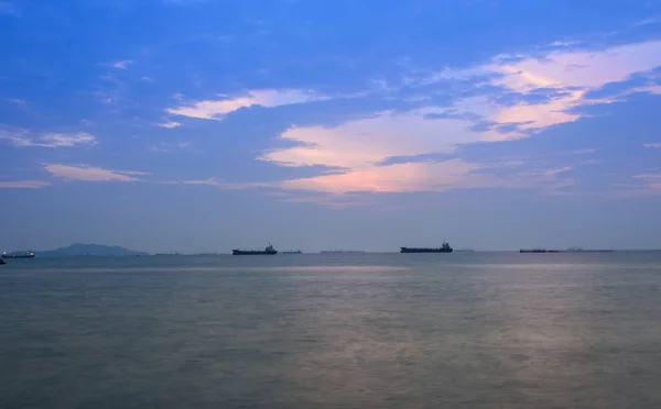 stock image sunset sky or dawn shines in blue, natural blue and sea boats in the sea or lake. Calm water background