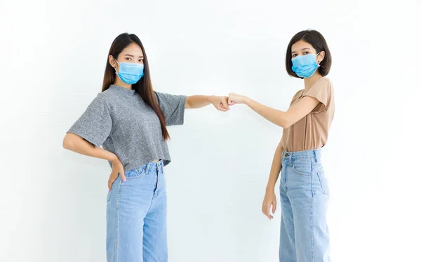 Two Asian Young Women Wearing Hygienic Face Mask Greeting Bumping — Stock Photo, Image