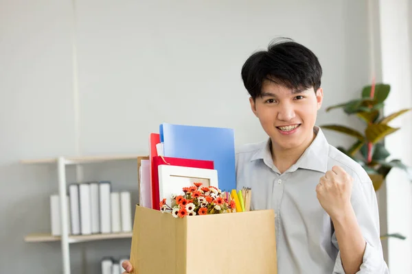 Asian male employee is showing confidence and pride in daring to change a new job.