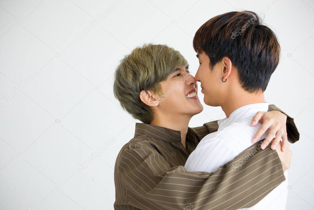 Happy Asian homosexual men or gay couples are embracing together isolated on white background. LGBTQ concept.