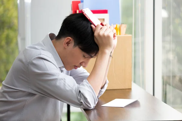 Asian man is stressed because he has been fired from work. Dismissed employees Due to the economic downturn and to the epidemic COVID-19.