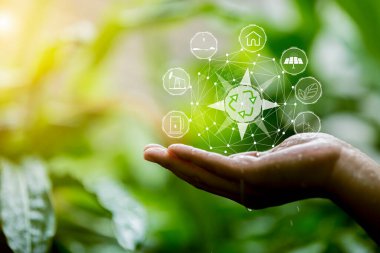 Çevre simgeleriyle el ele tutuşan teknoloji, yeşil arkaplanda Ağ bağlantısı üzerinden.