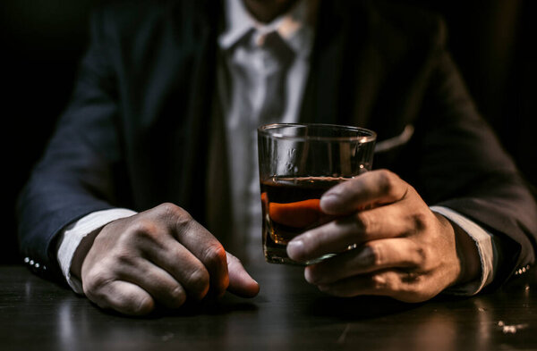 Closeup businessmen holding a glass of whiskey