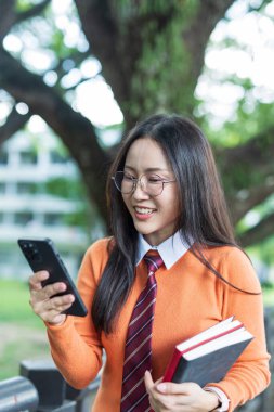 Students playing with mobile phones and laughing