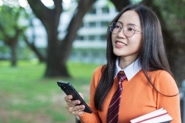Students playing with mobile phones and laughing