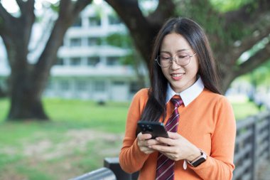 Students playing with mobile phones and laughing